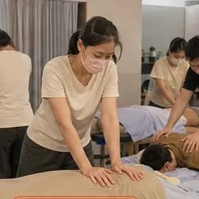 學員雙手下壓練習背部手法,後方還有其他兩組同時實作